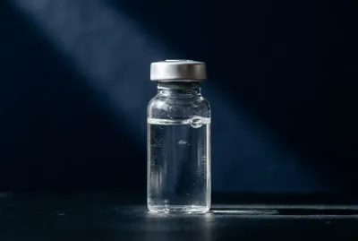 Vignette minimaliste d'un flacon médical sous un éclairage dramatique