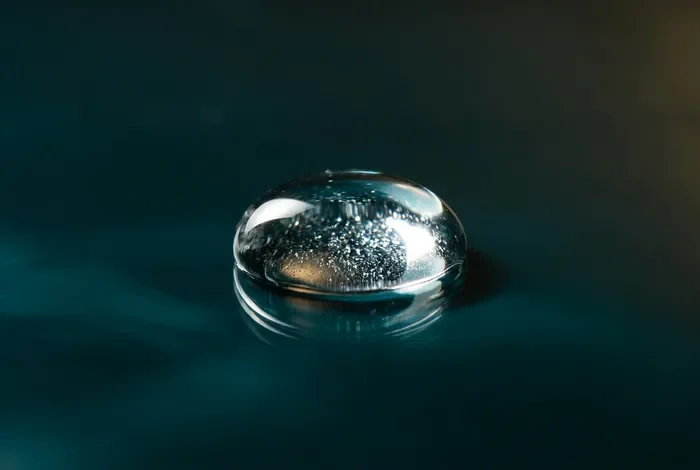 Parfum dans l'œil que faire : les gestes de secours immédiats Goutte de parfum isolée et minimaliste pour la miniature de l'article